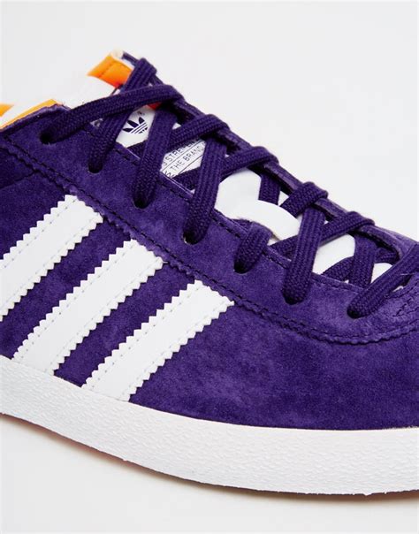 dark purple adidas shoes.